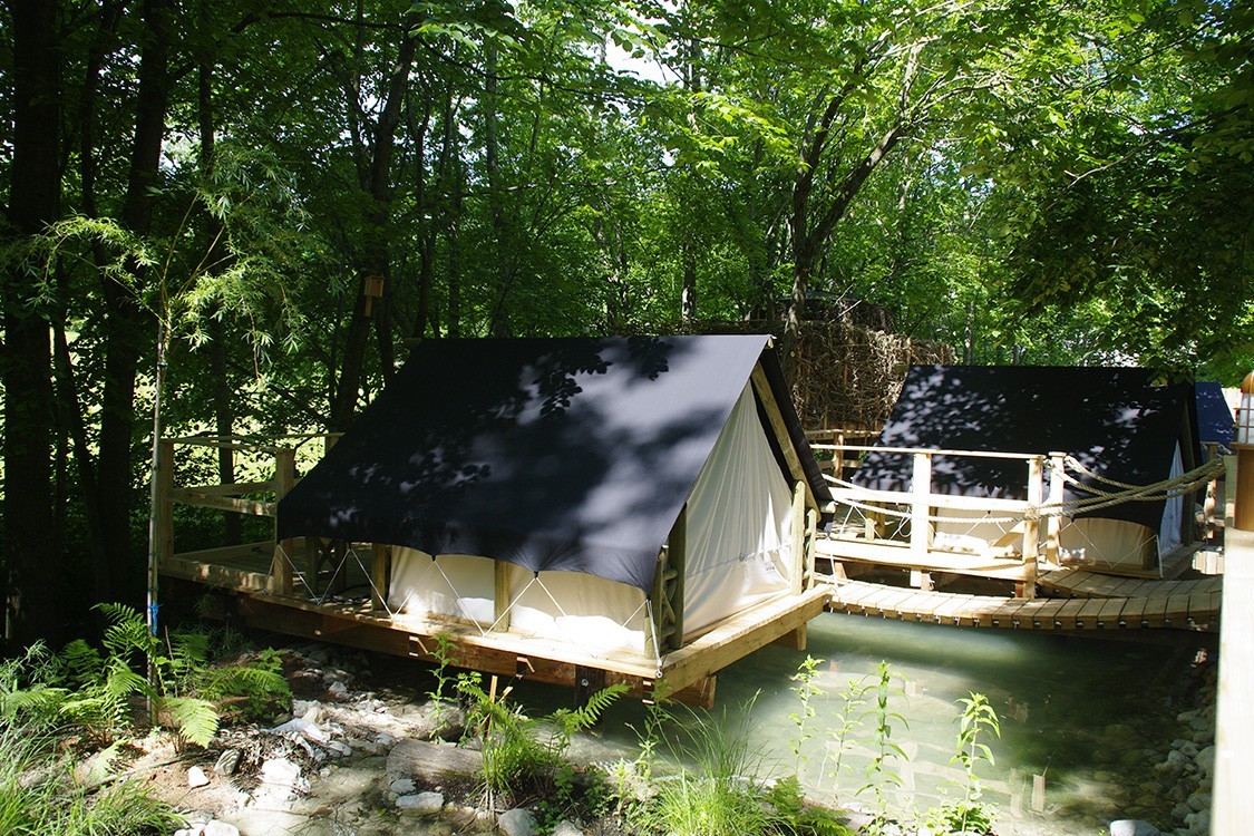 natural pool in slovenia with camping in tree houses