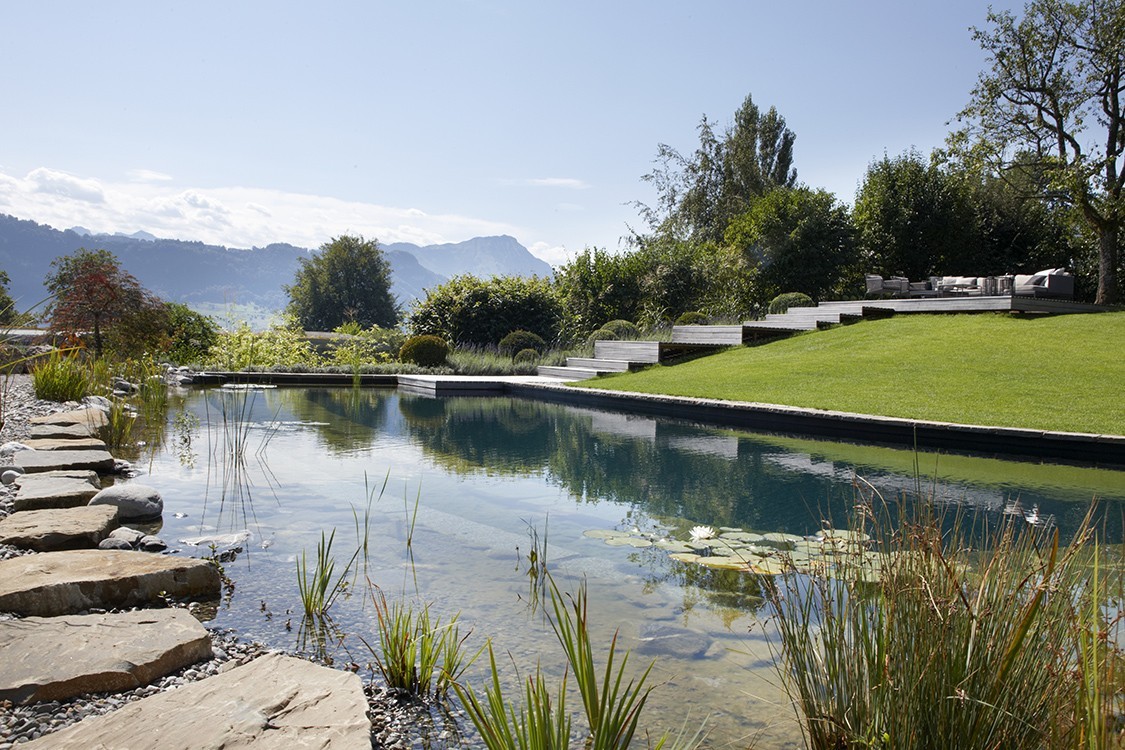 Natural Pool in Switzerland with a Harmonious Garden Concept