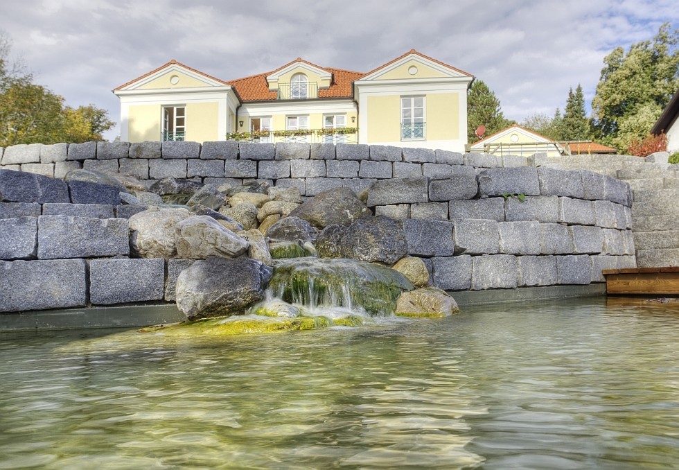 natural pool with natural stone wall and cascade